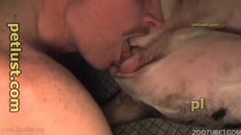 Guy with a spooky mustache bangs an obedient pup