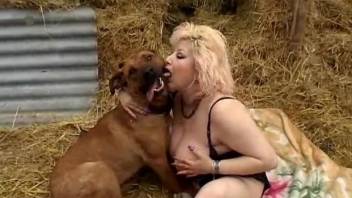 Big-boobed blonde mature banged by dog in the hayloft