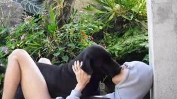 Modest twink and pretty black dog have sensual sex outdoors