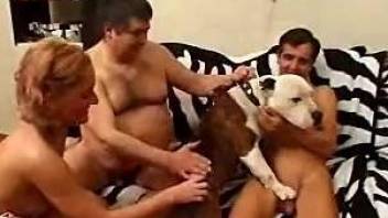 Blond-haired babe enjoys this bisexual orgy with 2 guys and 1 dog