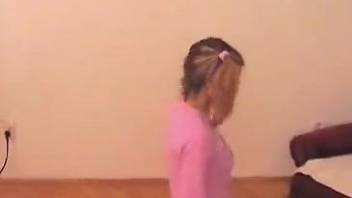 Pink top pigtailed blonde gets banged by a brown dog