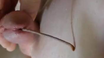 Bare dude shoves living worms into his cock for crazy solo act