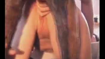 Voluptuous red-haired woman and her companion divide a large canine penis
